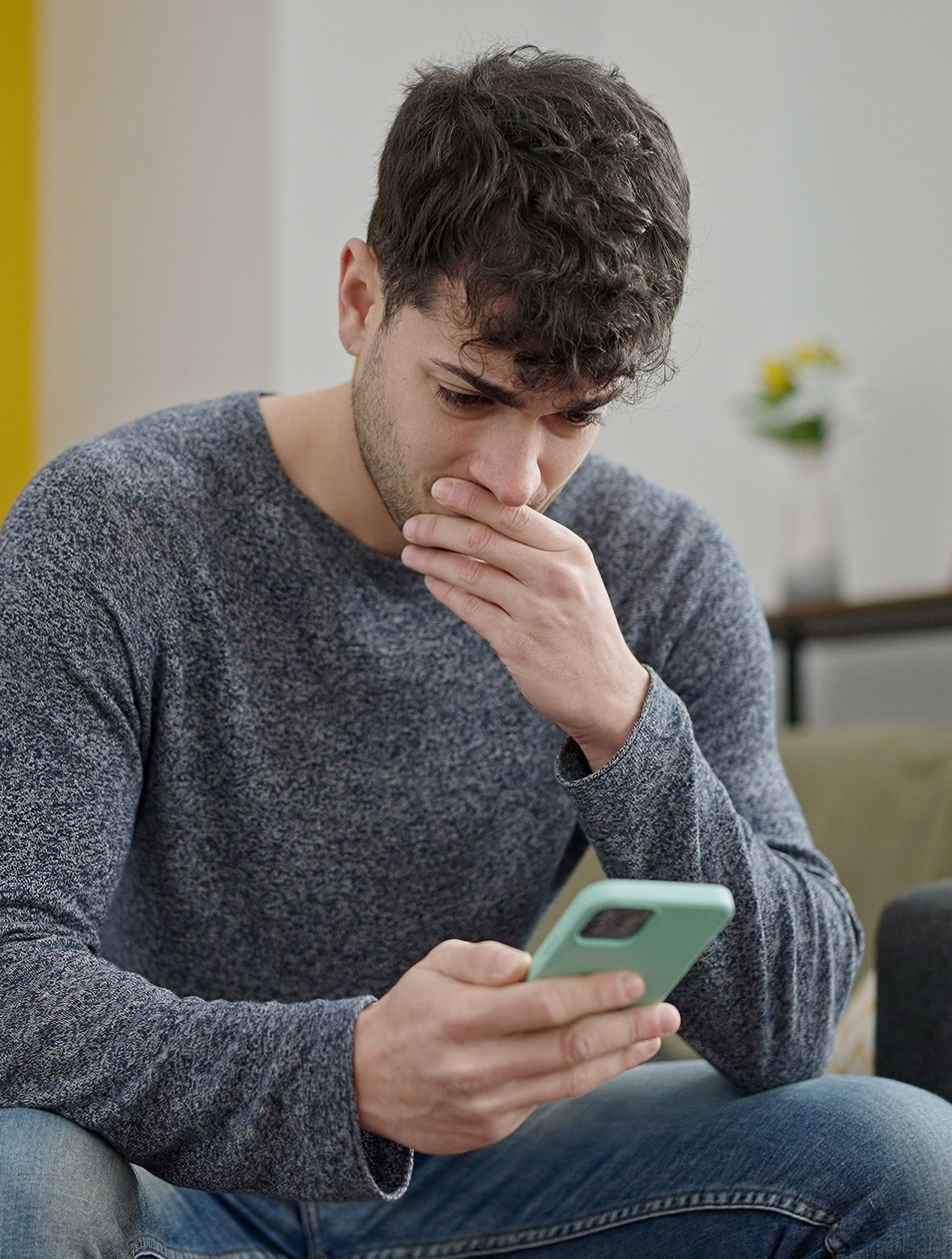 pensive man looking at his phone